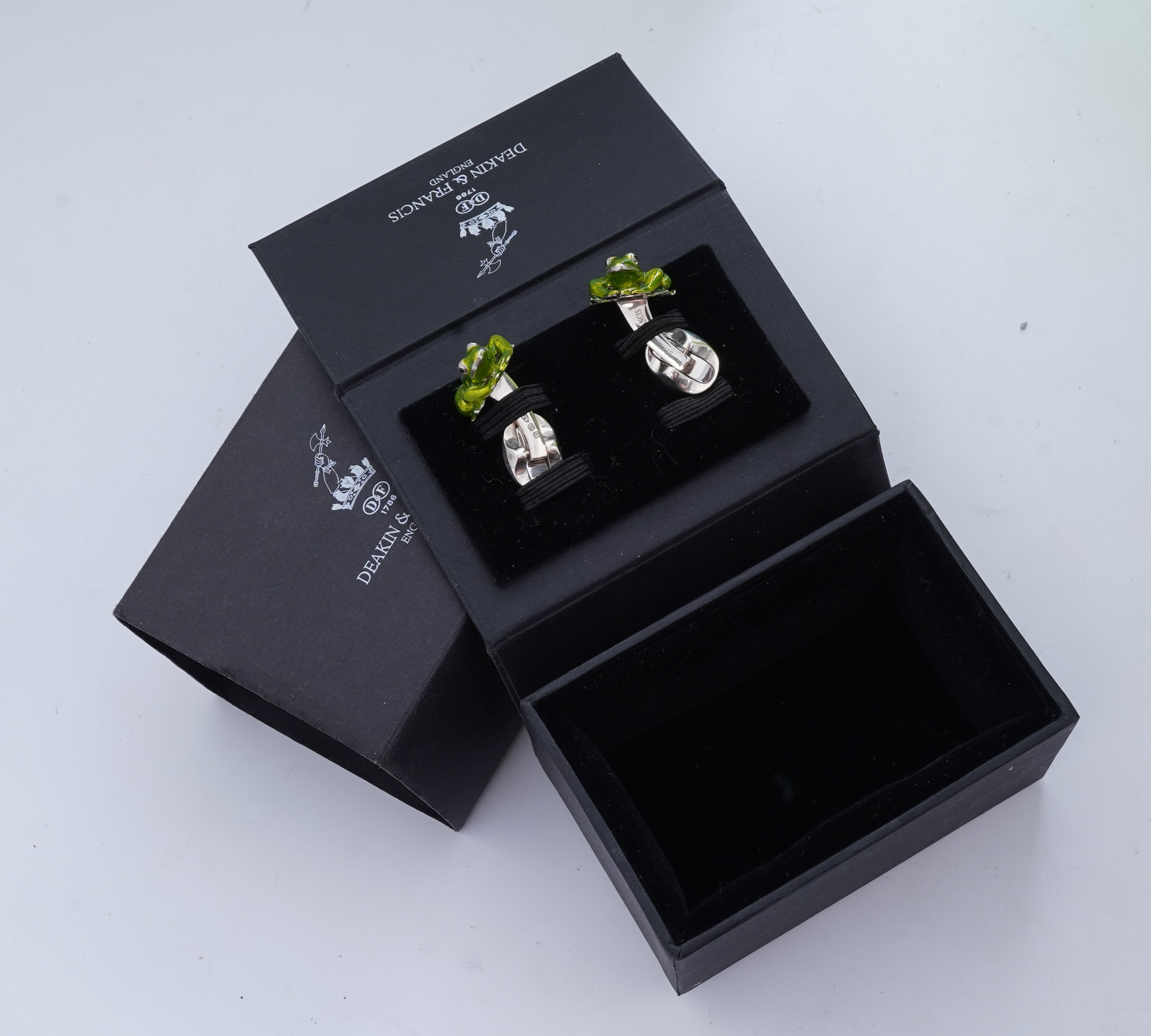 A modern pair of silver and polychrome enamel set oval cufflinks, 18mm.